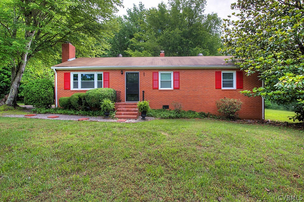 1267 Cardwell Road Crozier, VA 23039 - Photo 1 of 24 a front view of a house with garden