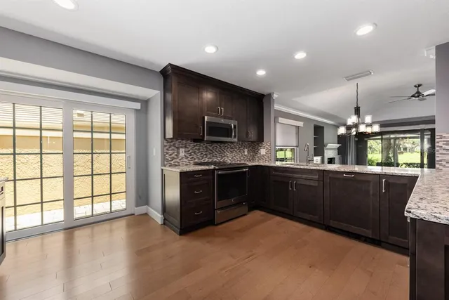 a kitchen with a sink stove and cabinets
