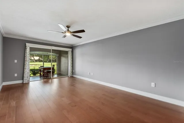 wooden floor in an empty room with a window