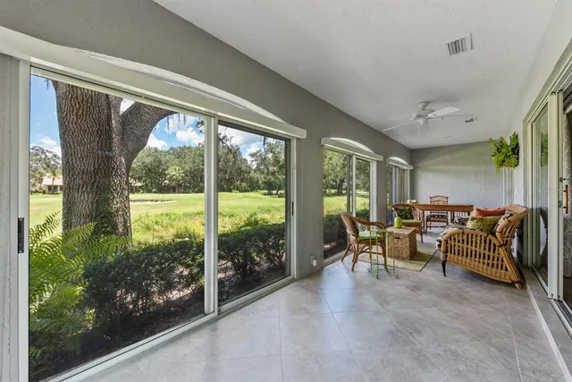 a living room with furniture and a floor to ceiling window