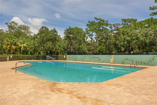 a view of a swimming pool with an outdoor space and seating area