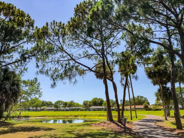 a view of a lake with houses in the back