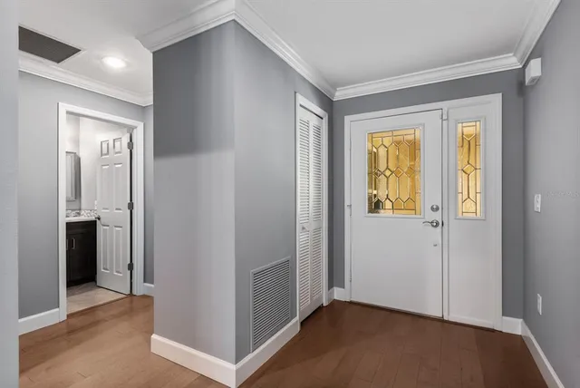 a view of an empty room with closet and a bathroom