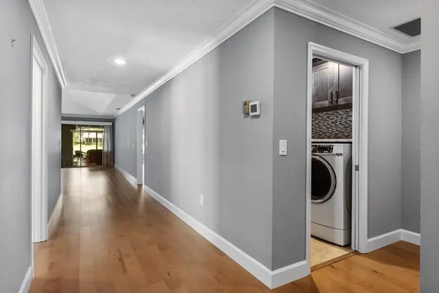 a view of a hallway with wooden floor windows and entryway