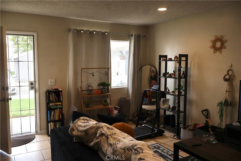 25929 Baylor Way Hemet, CA 92544 - Photo 14 of 21 a room with furniture a window and gym equipment