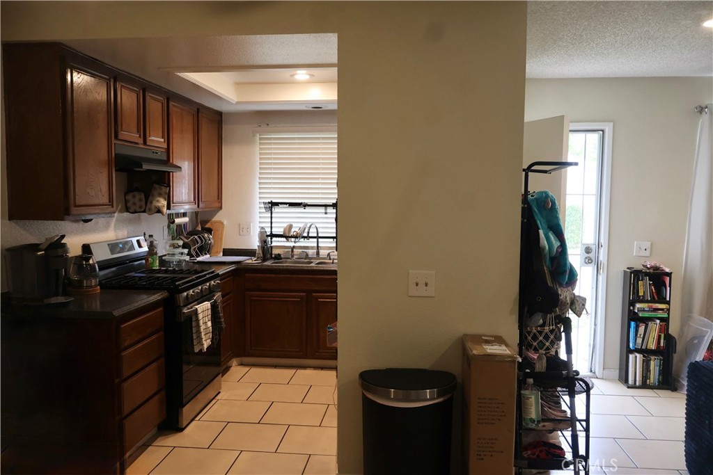 25929 Baylor Way Hemet, CA 92544 - Photo 3 of 21 a kitchen with a sink stove and refrigerator