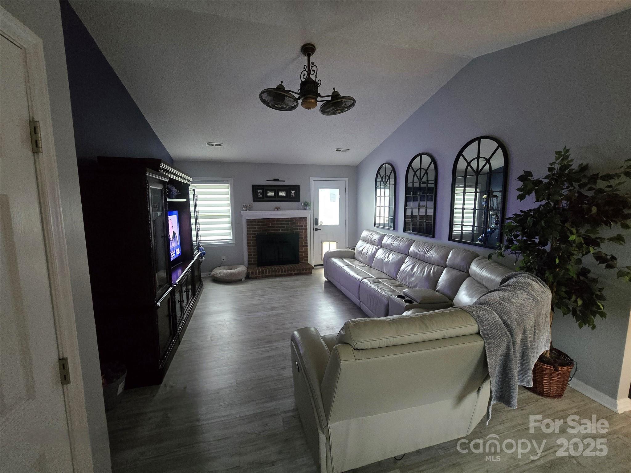 5202 Robin Lane Randleman, NC 27317 - Photo 19 of 48 a living room with furniture a fireplace and a flat screen tv