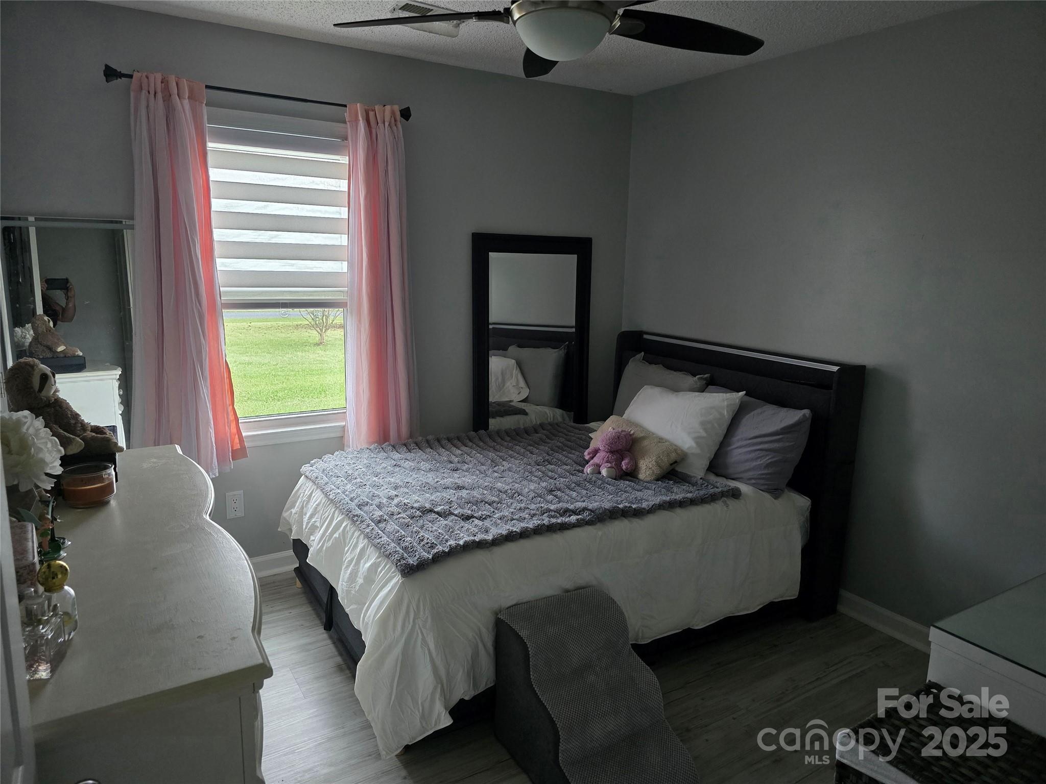 5202 Robin Lane Randleman, NC 27317 - Photo 2 of 48 a bed sitting in a bedroom next to a window