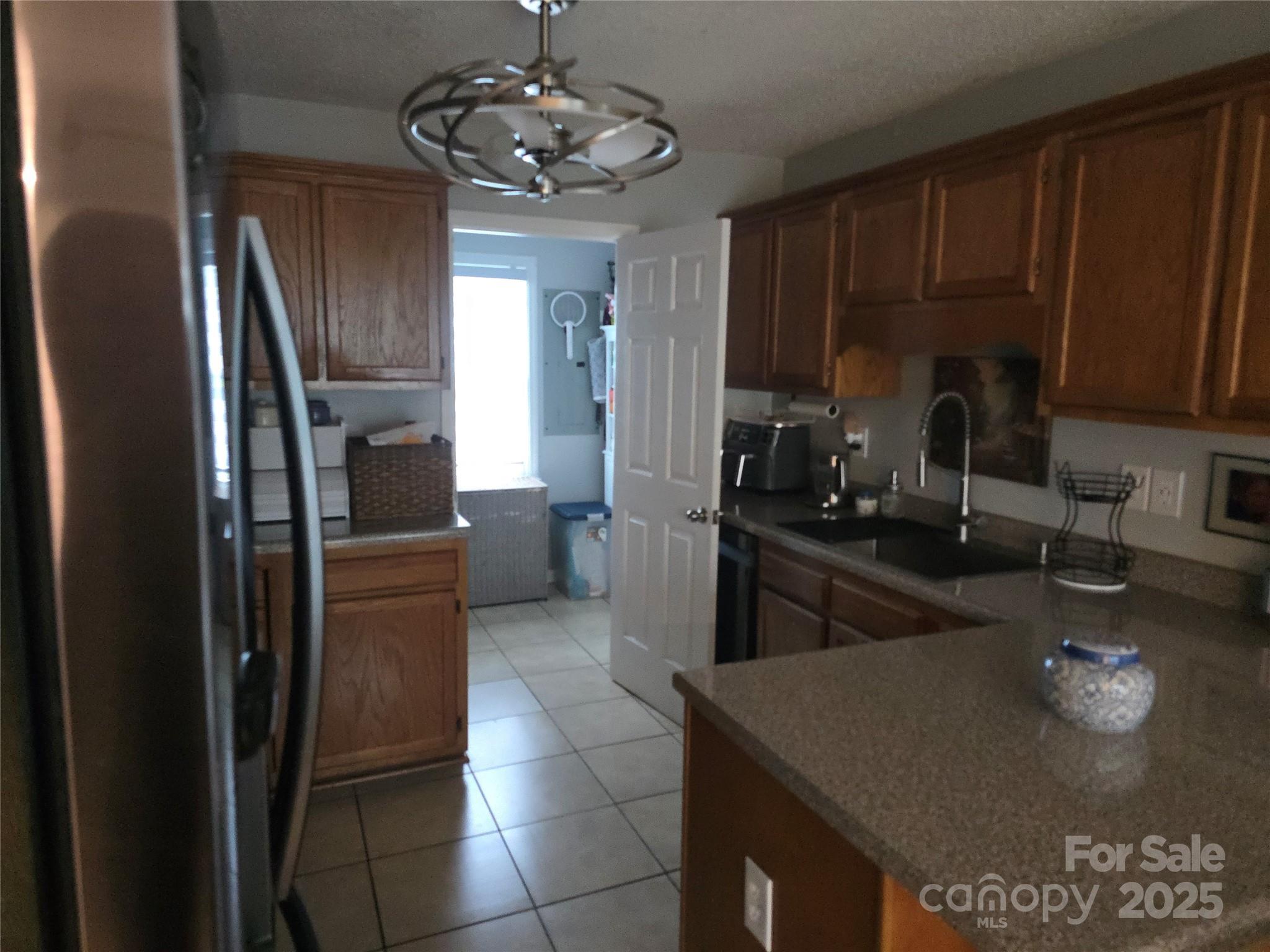 5202 Robin Lane Randleman, NC 27317 - Photo 25 of 48 a kitchen with stainless steel appliances granite countertop a sink refrigerator and cabinets