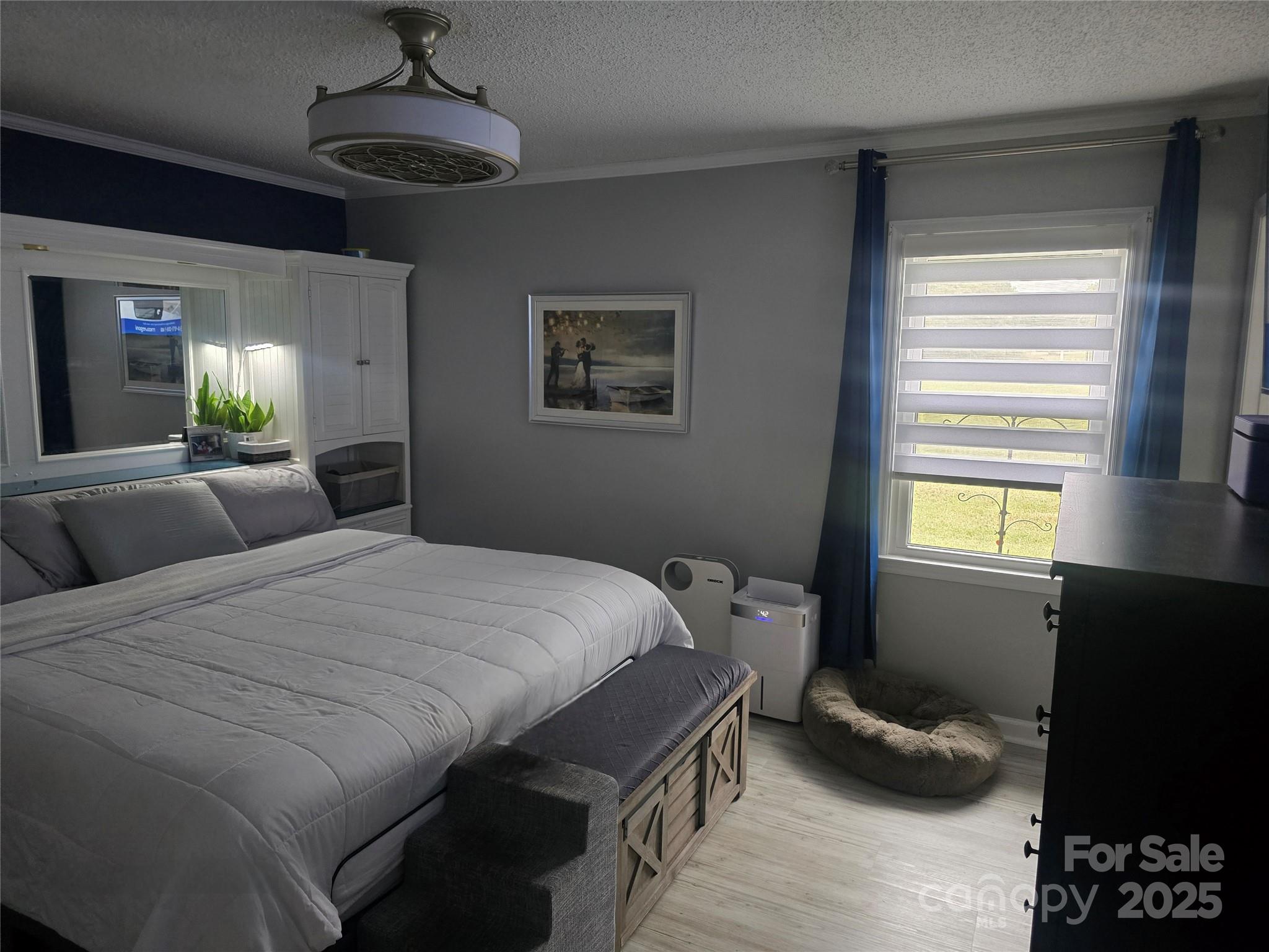 5202 Robin Lane Randleman, NC 27317 - Photo 47 of 48 a bedroom with a bed and a chandelier