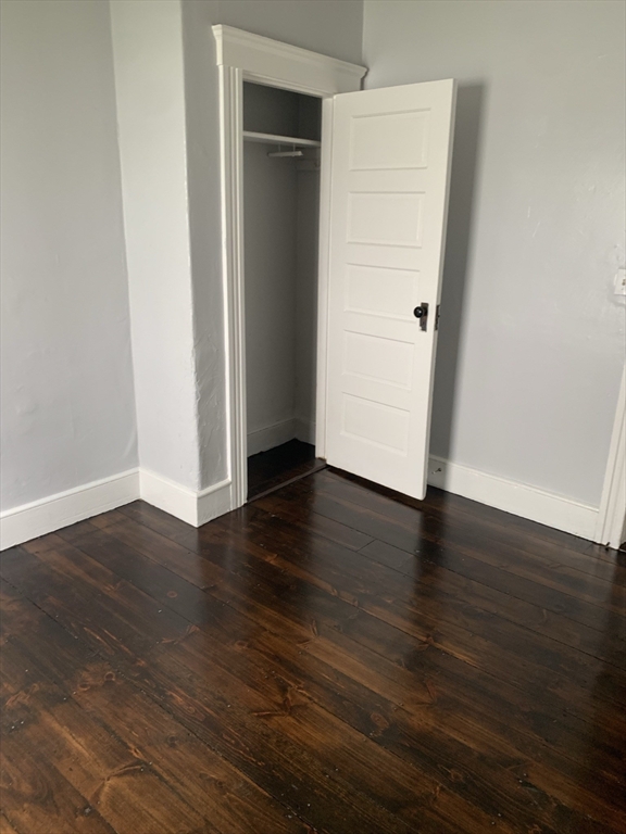 8 Knowlton Avenue, Unit 2 Worcester, MA 01603 - Photo 12 of 14 an empty room with wooden floor and closet