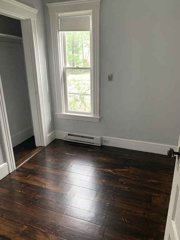 8 Knowlton Avenue, Unit 2 Worcester, MA 01603 - Photo 14 of 14 an empty room with wooden floor and windows