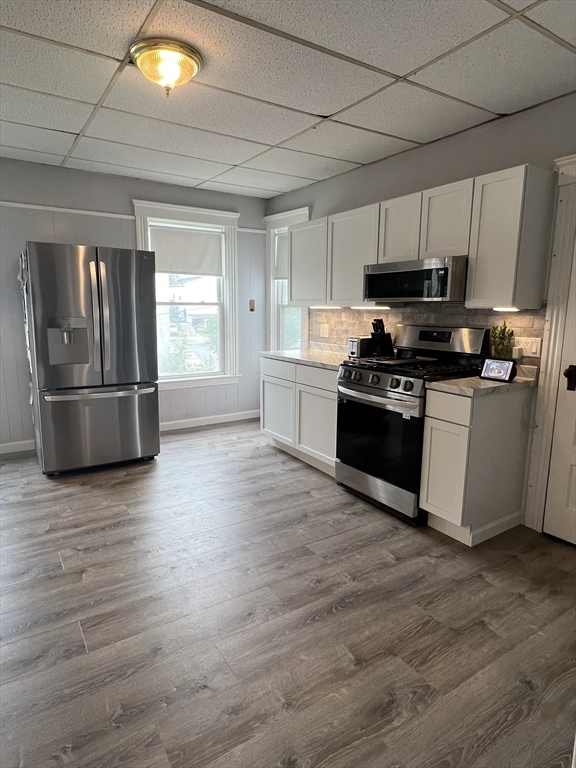 8 Knowlton Avenue, Unit 2 Worcester, MA 01603 - Photo 4 of 14 a kitchen with stainless steel appliances granite countertop a stove and a refrigerator