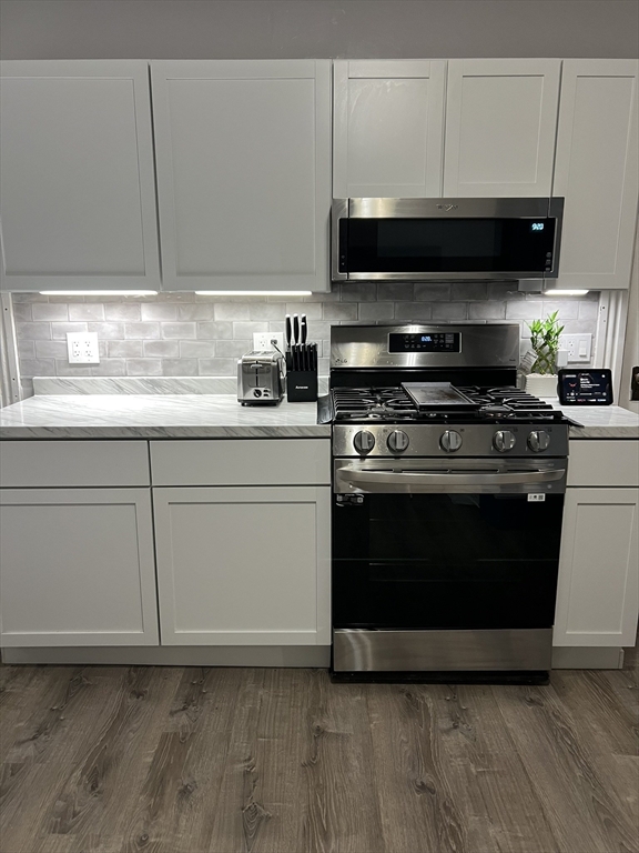 8 Knowlton Avenue, Unit 2 Worcester, MA 01603 - Photo 6 of 14 a kitchen with granite countertop a stove and a microwave