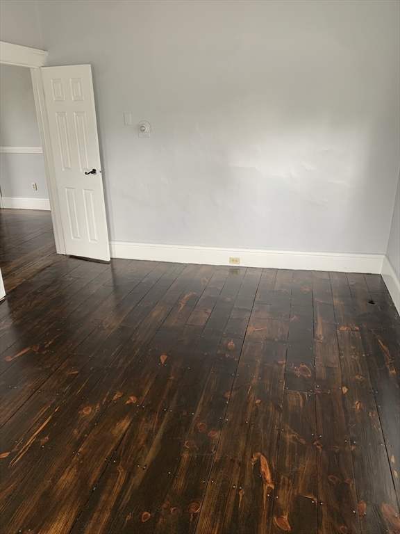 8 Knowlton Avenue, Unit 2 Worcester, MA 01603 - Photo 10 of 14 an empty room with wooden floor and cabinet
