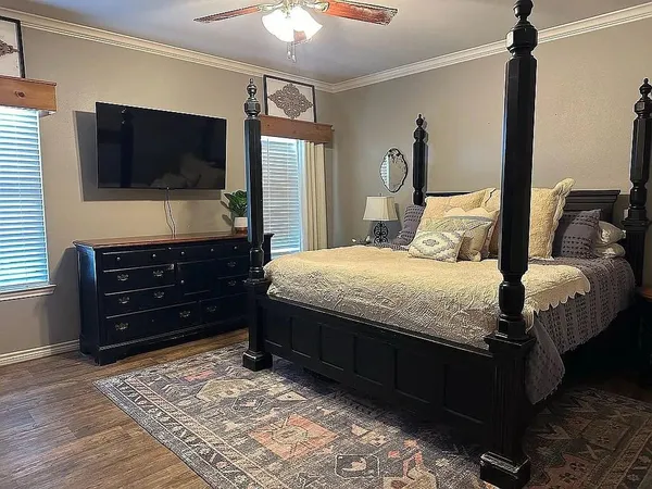 a bedroom with a bed and a flat screen tv