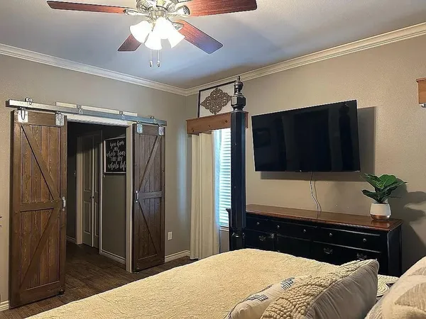 a bedroom with a bed and a flat screen tv