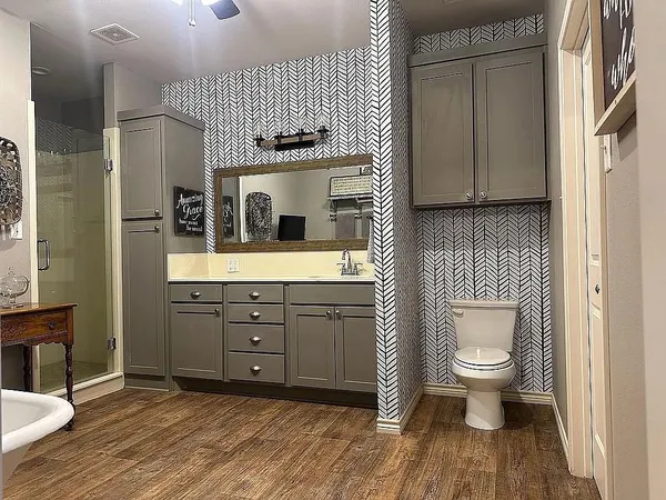 a bathroom with a sink a toilet and mirror