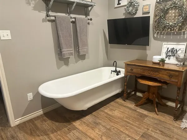 a bathroom with a bathtub and a sink