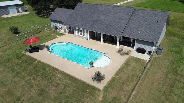 an aerial view of a house with a yard
