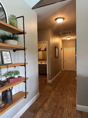 a view of hallway with wooden floor