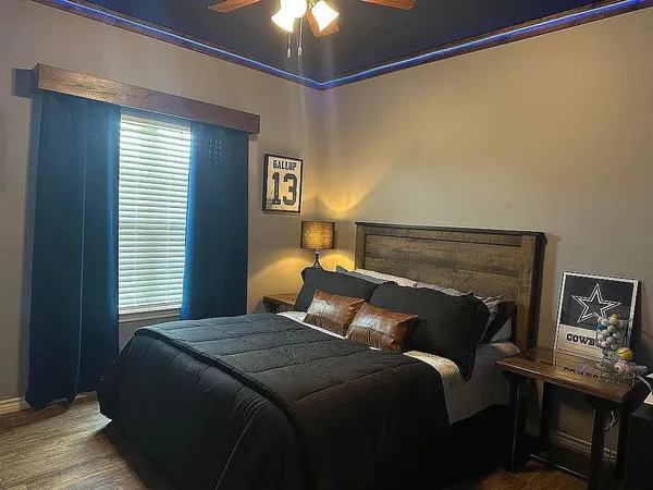 a bedroom with a bed and a chandelier