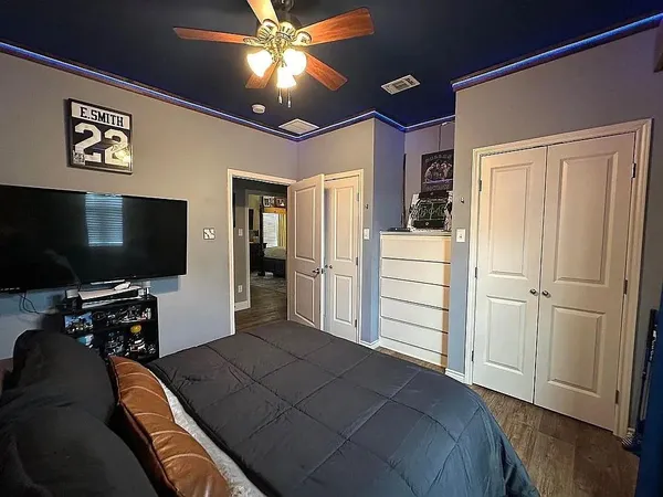 a bedroom with a bed and a flat screen tv