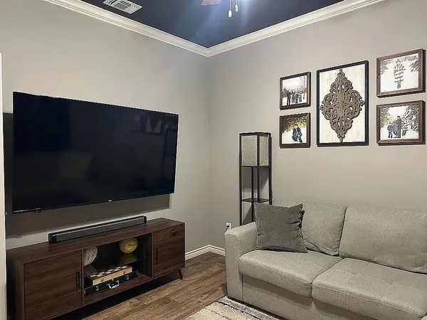 a living room with furniture and a flat screen tv