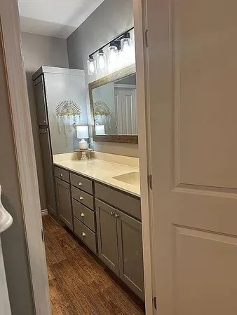 a bathroom with a double vanity sink and mirror