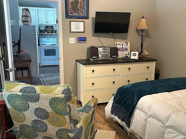 a bedroom with a bed and flat screen tv