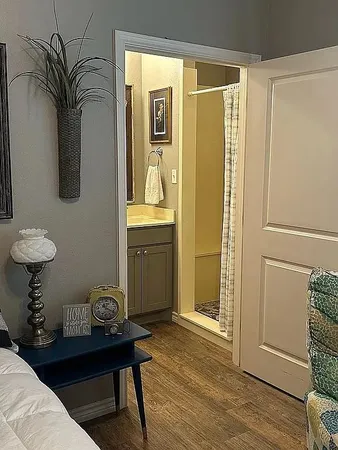 a view of hallway with furniture and wooden floor