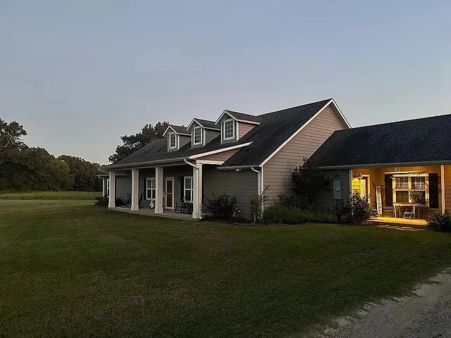 a front view of a house with a garden