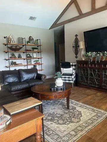 a living room with furniture and a flat screen tv