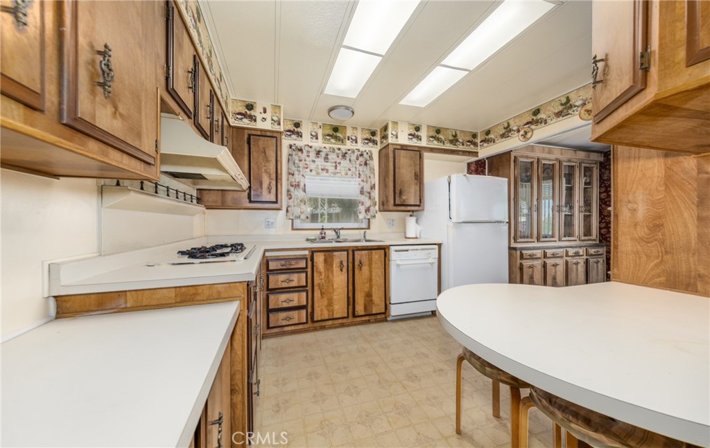 9401 Sharondale Road Calimesa, CA 92320 - Photo 12 of 23 a kitchen with a stove a refrigerator and a sink