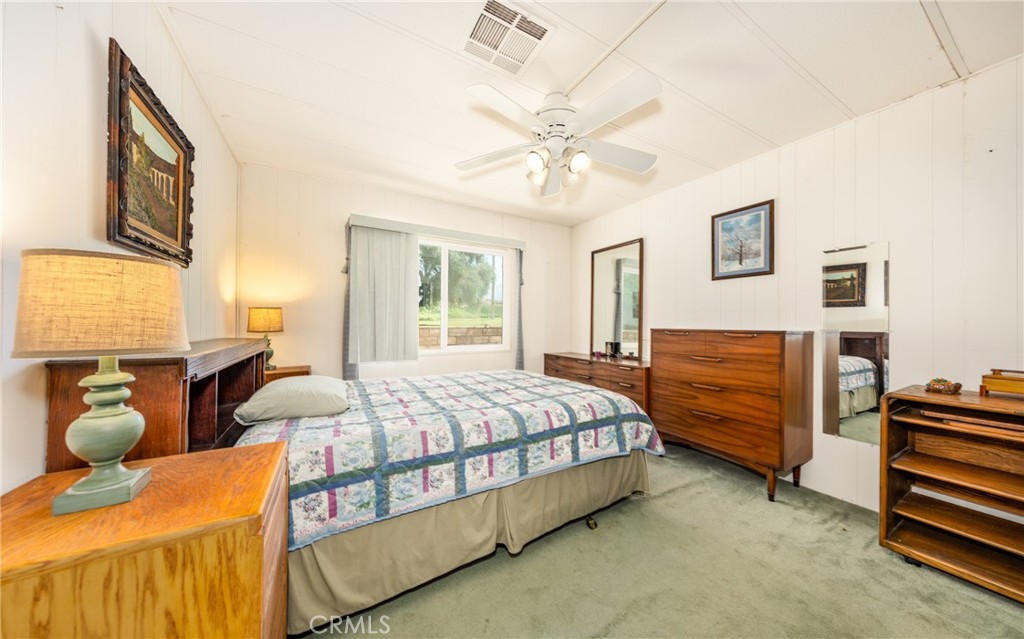9401 Sharondale Road Calimesa, CA 92320 - Photo 18 of 23 a bedroom with a bed and a chandelier