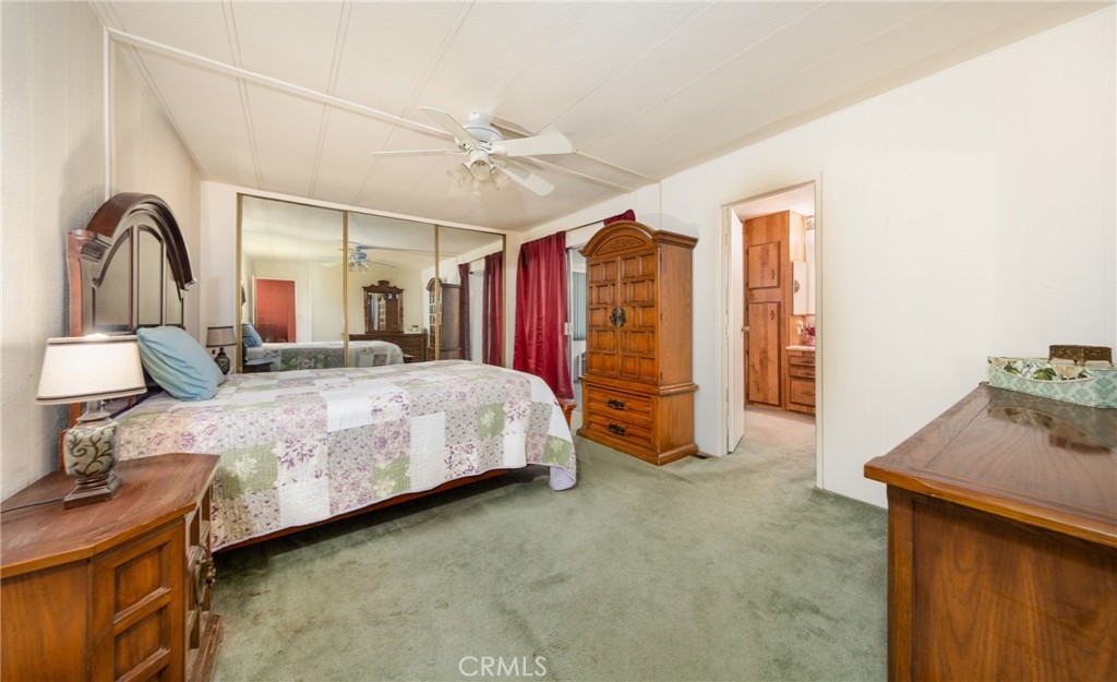 9401 Sharondale Road Calimesa, CA 92320 - Photo 19 of 23 a bedroom with a bed next to a window and a dresser