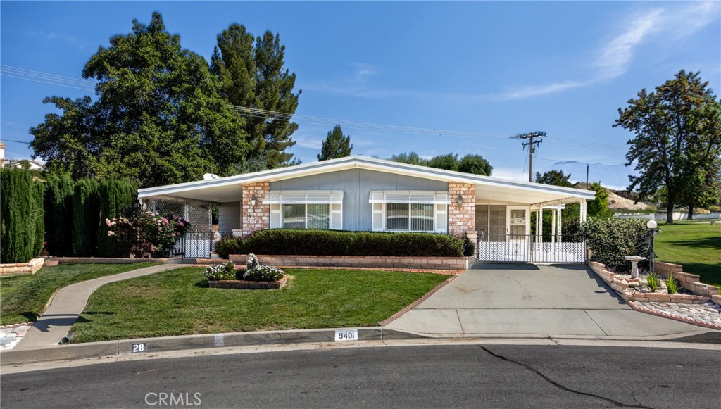 9401 Sharondale Road Calimesa, CA 92320 - Photo 2 of 23 a front view of a house with a yard table and chairs