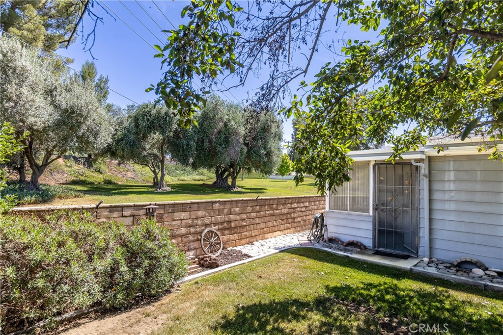 9401 Sharondale Road Calimesa, CA 92320 - Photo 23 of 23 a view of a backyard with wooden fence and a large tree