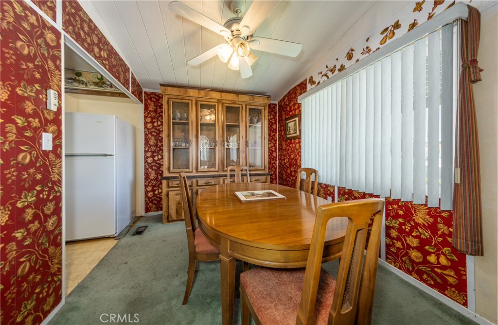 9401 Sharondale Road Calimesa, CA 92320 - Photo 9 of 23 a view of a dining room with furniture and a chandelier fan