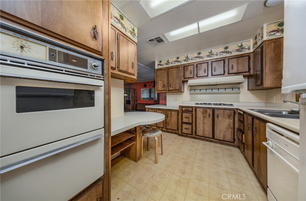 9401 Sharondale Road Calimesa, CA 92320 - Photo 10 of 23 a kitchen with stainless steel appliances granite countertop a stove and a sink
