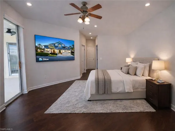 a bedroom with a bed and a painting on the wall