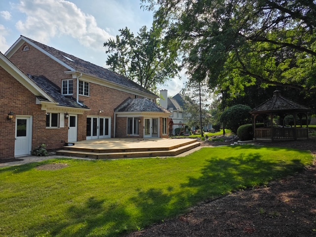 1 Hidden Lake Drive Burr Ridge, IL 60527 - Photo 14 of 24 a front view of a house with swimming pool having outdoor seating