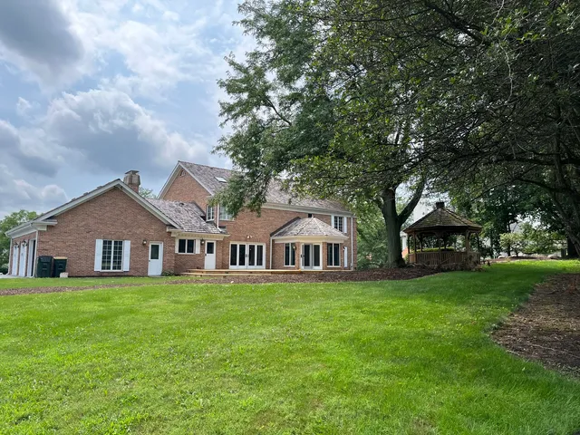 a view of a backyard with large trees