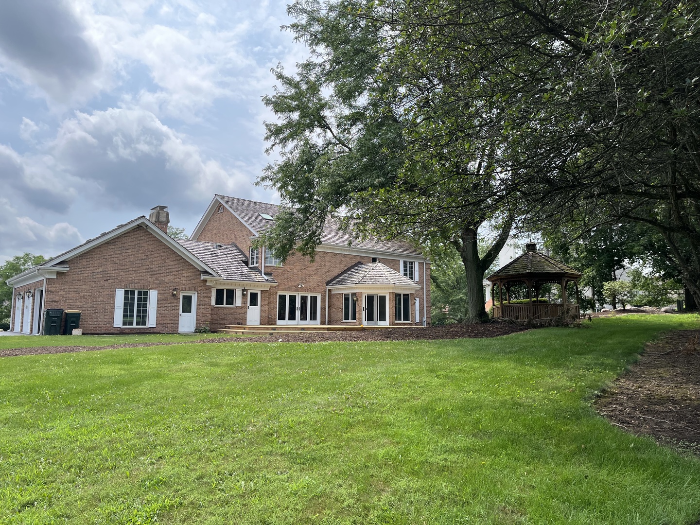 1 Hidden Lake Drive Burr Ridge, IL 60527 - Photo 18 of 24 a view of a house with a big yard and large trees