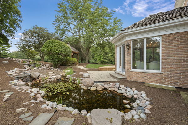 1 Hidden Lake Drive Burr Ridge, IL 60527 - Photo 19 of 24 a view of a backyard with large trees