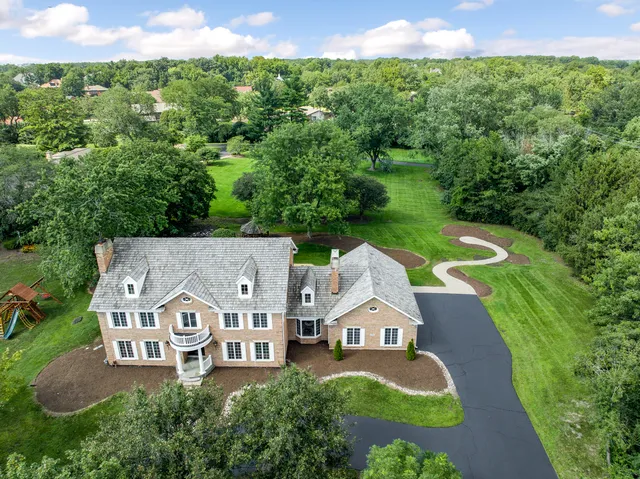 an aerial view of a house with garden space and street view