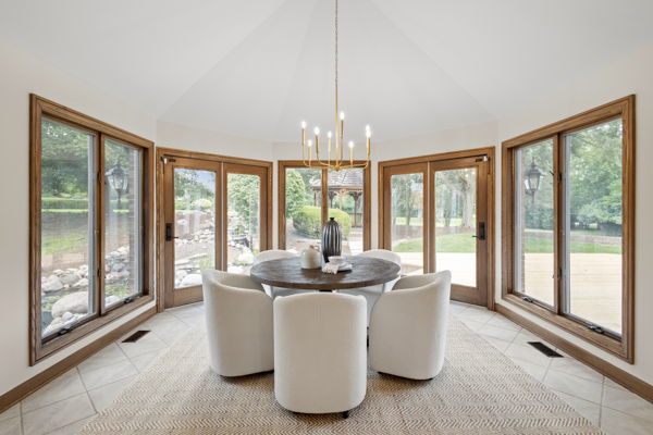 1 Hidden Lake Drive Burr Ridge, IL 60527 - Photo 7 of 24 a dining room with furniture and large windows