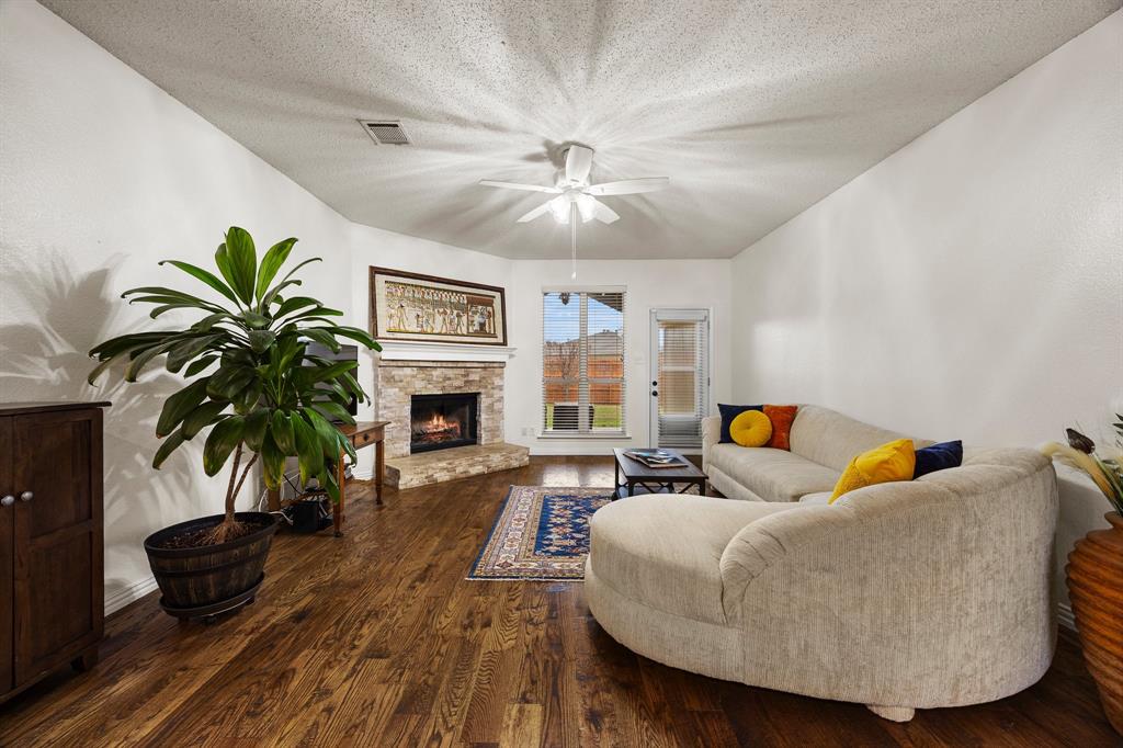 7210 Mercurys Road Rowlett, TX 75089 - Photo 11 of 26 a living room with furniture and a fireplace