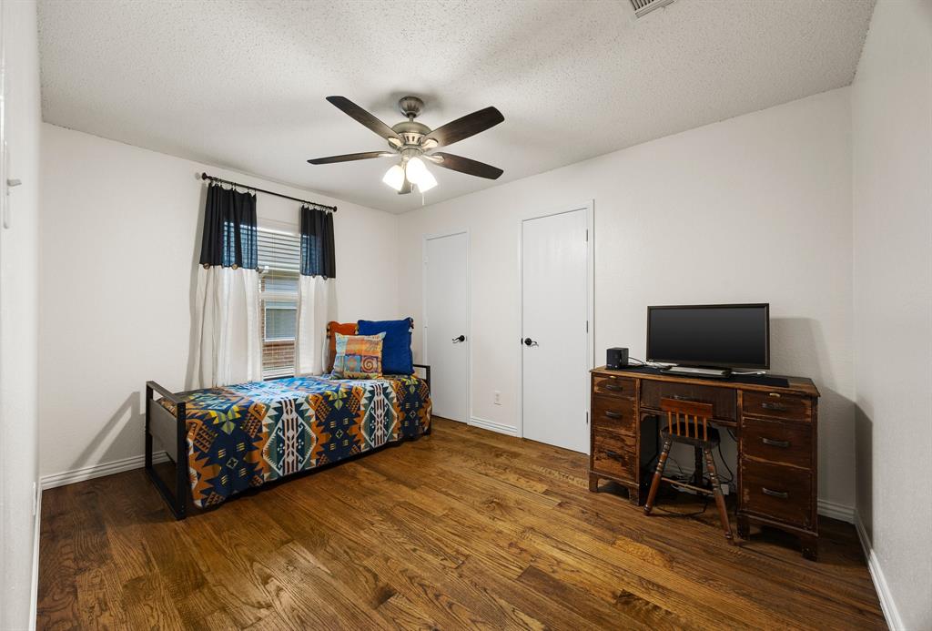 7210 Mercurys Road Rowlett, TX 75089 - Photo 21 of 26 a bedroom with a bed and a television