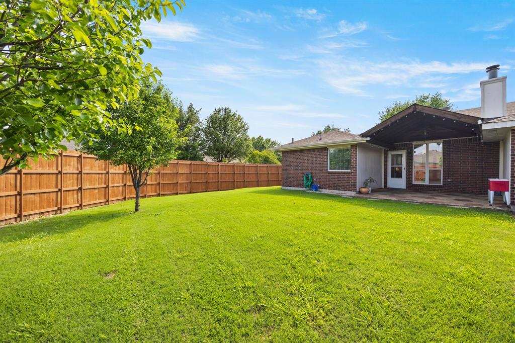7210 Mercurys Road Rowlett, TX 75089 - Photo 22 of 26 a view of a house with a backyard